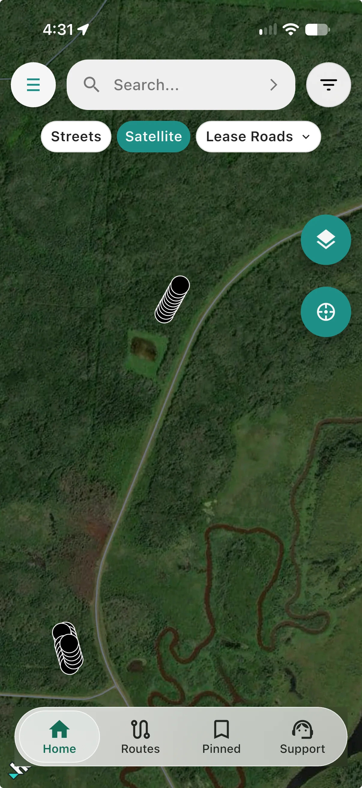 Satellite selected; well markers appear over forest with no visible new pad